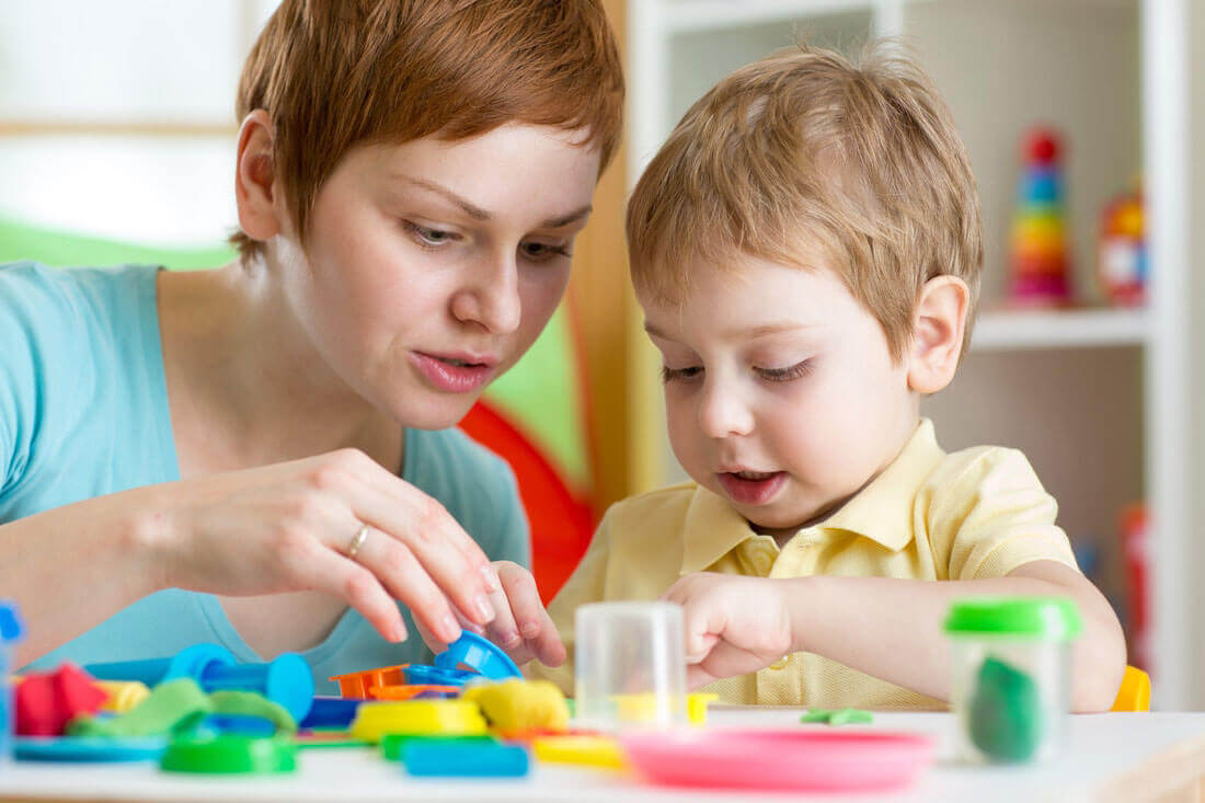 Mother and son play with toys
